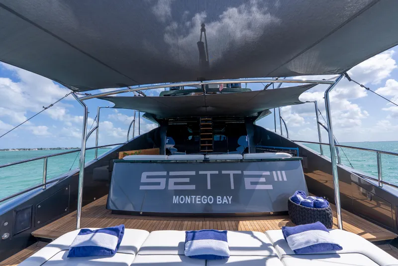 Slide: The Image of Luxurious Palmer Johnson 120 yacht deck with sun loungers, shade canopy, and ocean view. - 44