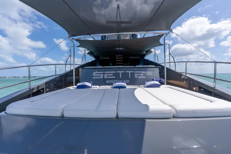 Slide: The Image of Luxurious Palmer Johnson 120 yacht deck with sunbeds, 2003 model, under a clear blue sky. - 45