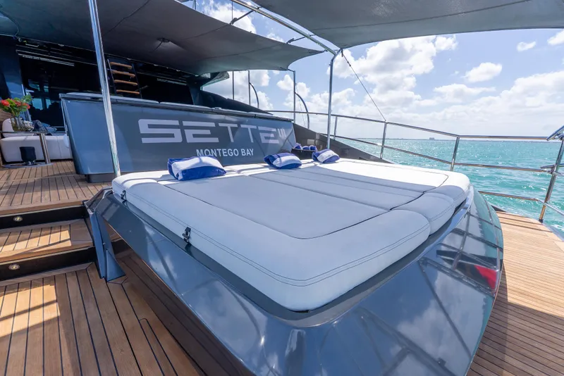Slide: The Image of Luxurious Palmer Johnson 120 yacht deck with sunbed, ocean view, and clear skies. - 48