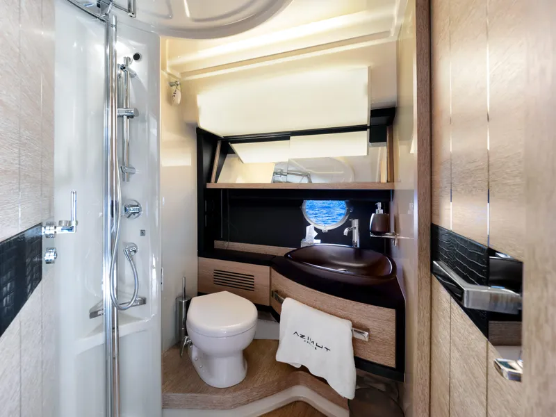 Slide: The Image of Luxurious bathroom in a 2013 Azimut 64 yacht with modern fixtures and ocean view. - 11