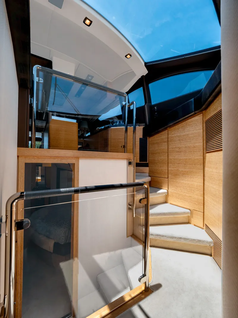 Slide: The Image of Interior view of 2013 Azimut 64 yacht with modern design and wooden accents. - 13