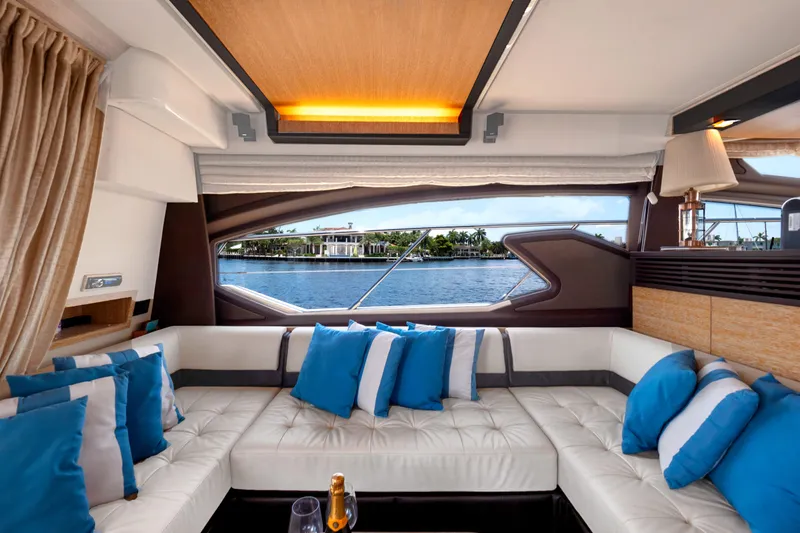 Slide: The Image of Luxurious interior of 2013 Azimut 64 yacht with plush seating and scenic water view. - 14