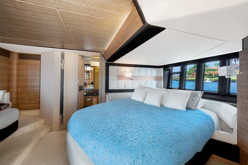 Slide: The Image of Luxurious bedroom interior of 2013 Azimut 64 yacht with blue bedding and scenic window view. - 7