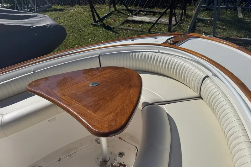 Slide: The Image of 2011 Hunt Yachts Surfhunter 25 CC with elegant wood table and cushioned seating. - 5