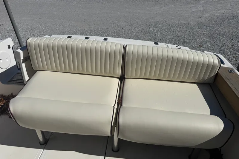 Slide: The Image of 2011 Hunt Yachts Surfhunter 25 CC boat seating, featuring cream-colored upholstery. - 8