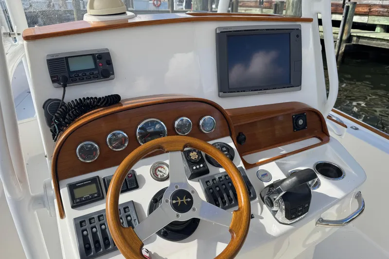 Slide: The Image of 2011 Hunt Yachts Surfhunter 25 Center Console dashboard with steering wheel and navigation equipment. - 4