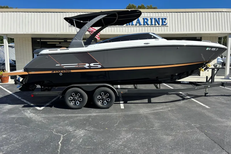 The Image of 2022 Four Winns H260 RS boat on trailer, parked outside a marine dealership. - 0