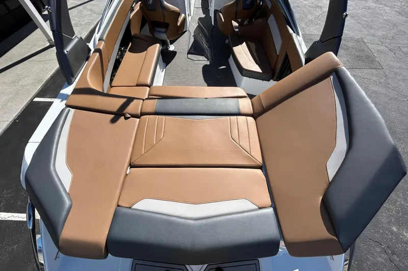 Slide: The Image of 2022 Four Winns H260 RS boat interior with tan and gray seating. - 11