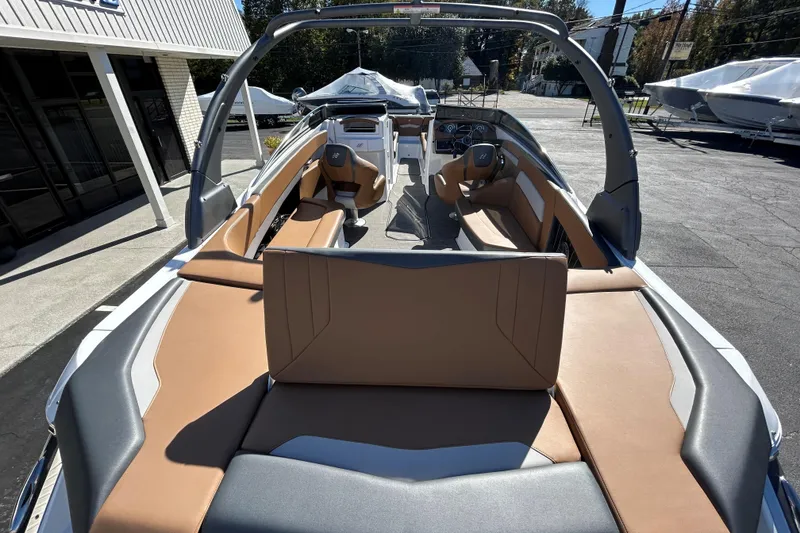 Slide: The Image of 2022 Four Winns H260 RS boat interior with tan and gray seating, outdoor display. - 13