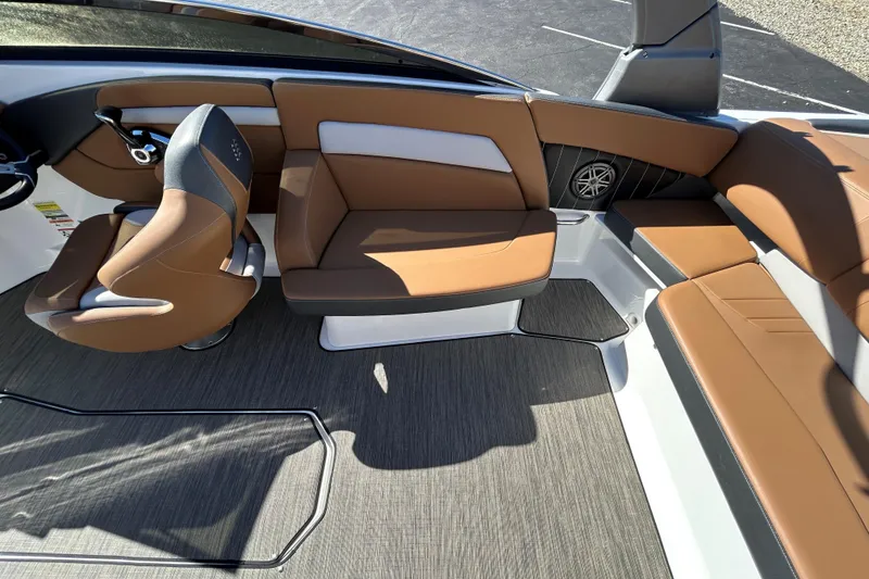 Slide: The Image of 2022 Four Winns H260 RS boat interior with brown seating and modern design. - 15