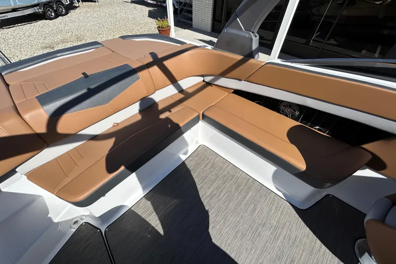 Slide: The Image of 2022 Four Winns H260 RS boat interior with tan seating and modern design. - 16