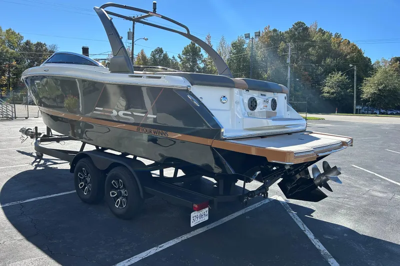 Slide: The Image of 2022 Four Winns H260 RS boat on trailer in parking lot, rear view. - 27