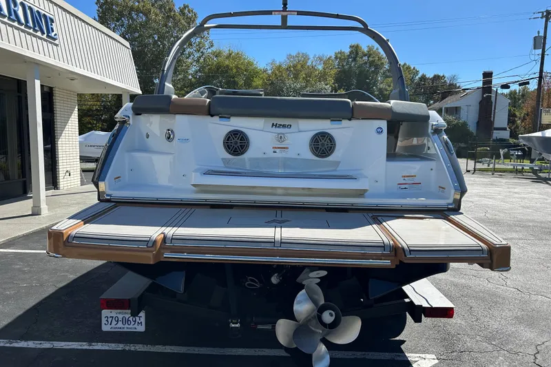 Slide: The Image of 2022 Four Winns H260 RS boat, rear view, showcasing swim platform and propeller. - 28