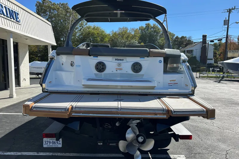 Slide: The Image of 2022 Four Winns H260 RS boat rear view with swim platform and propeller. - 6