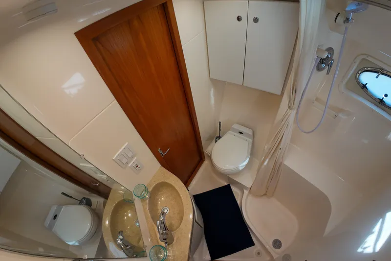 Slide: The Image of 1999 Tiara Yachts 3500 Express bathroom with shower, sink, and toilet. - 103