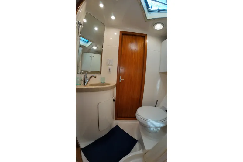 Slide: The Image of Bathroom interior of 1999 Tiara Yachts 3500 Express with sink, mirror, and toilet. - 105