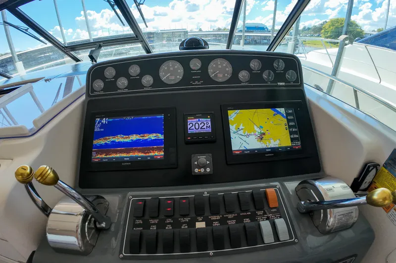 Slide: The Image of Control panel of a 1999 Tiara Yachts 3500 Express with navigation displays and gauges. - 109