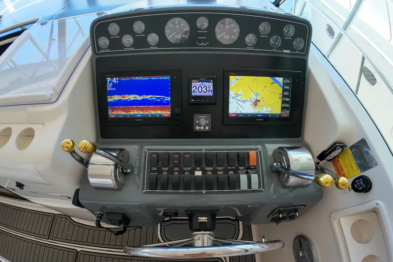 Slide: The Image of Control panel of a 1999 Tiara Yachts 3500 Express with navigation displays and gauges. - 110