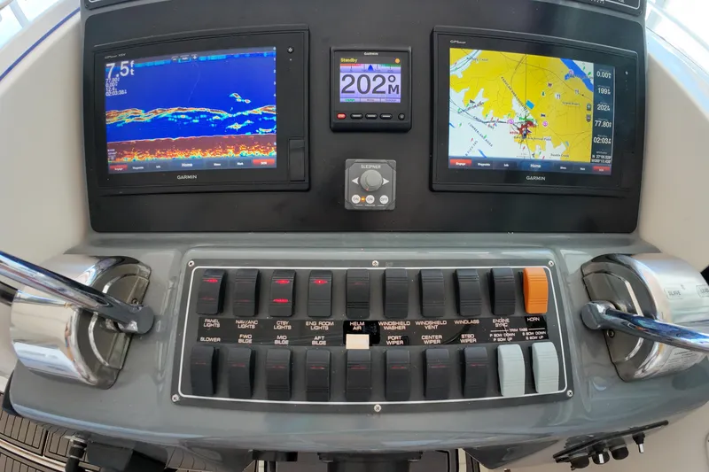 Slide: The Image of Control panel of a 1999 Tiara Yachts 3500 Express with navigation displays. - 111