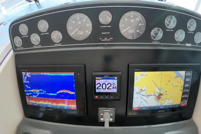 Slide: The Image of Dashboard of a 1999 Tiara Yachts 3500 Express with navigation and engine displays. - 113