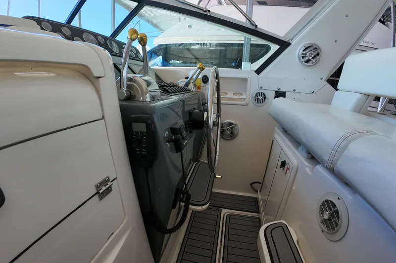 Slide: The Image of 1999 Tiara Yachts 3500 Express cockpit with steering wheel and control panel. - 115