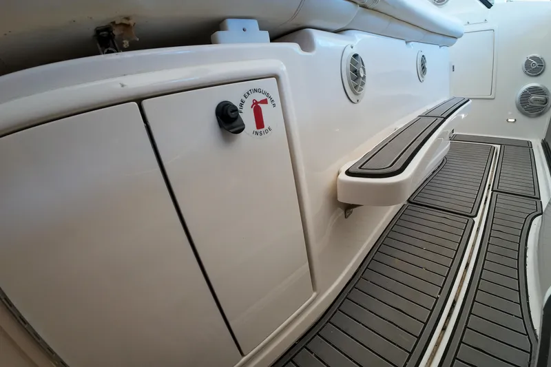 Slide: The Image of 1999 Tiara Yachts 3500 Express interior with fire extinguisher compartment and non-slip flooring. - 117
