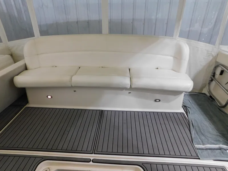 Slide: The Image of 1999 Tiara Yachts 3500 Express interior with white seating and sleek flooring. - 12