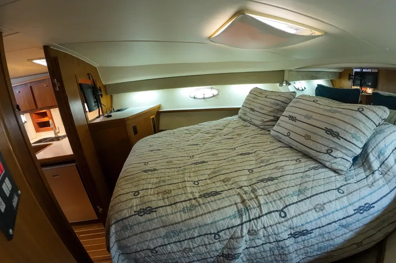 Slide: The Image of 1999 Tiara Yachts 3500 Express cabin interior with cozy bed and modern amenities. - 121