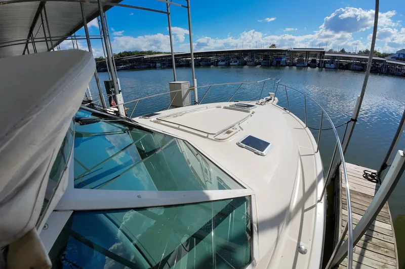 Slide: The Image of 1999 Tiara Yachts 3500 Express docked, showcasing sleek design and waterfront view. - 133
