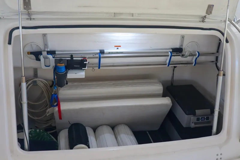 Slide: The Image of Storage compartment of a 1999 Tiara Yachts 3500 Express, featuring organized equipment and accessories. - 142
