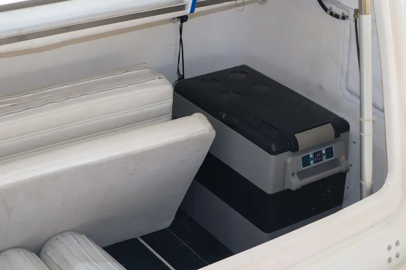 Slide: The Image of 1999 Tiara Yachts 3500 Express interior with storage and cooler. - 144