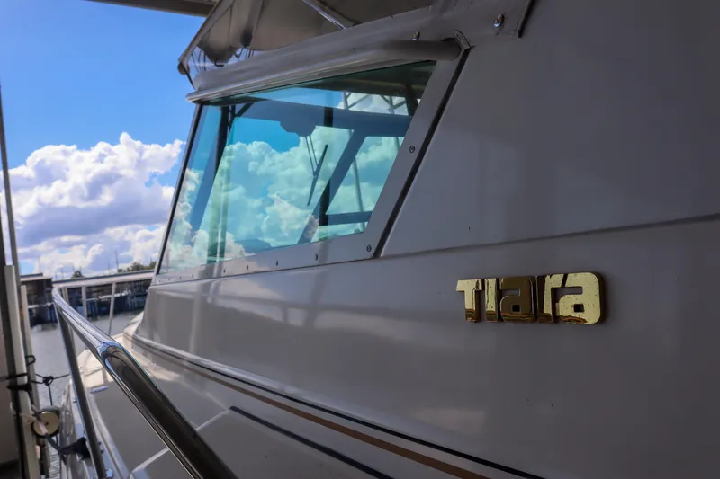 Slide: The Image of 1999 Tiara Yachts 3500 Express boat with clear sky reflection on windows. - 146