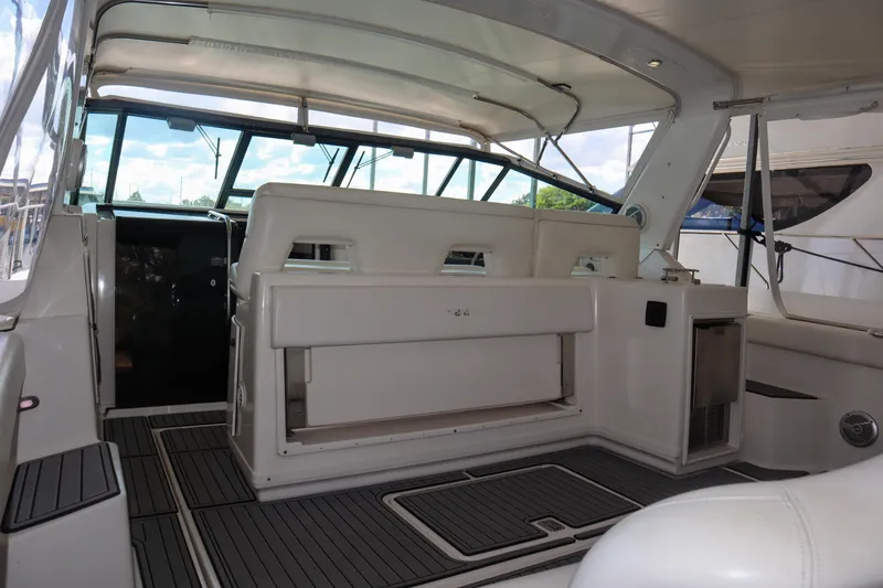 Slide: The Image of 1999 Tiara Yachts 3500 Express interior with seating and helm, showcasing luxury design. - 148