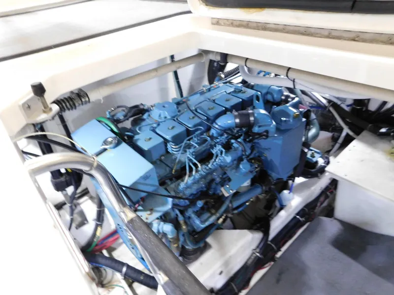 Slide: The Image of Engine compartment of a 1999 Tiara Yachts 3500 Express, showcasing a blue marine engine. - 15