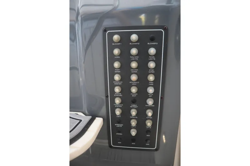 Slide: The Image of Control panel of a 1999 Tiara Yachts 3500 Express, featuring various switches and buttons. - 150