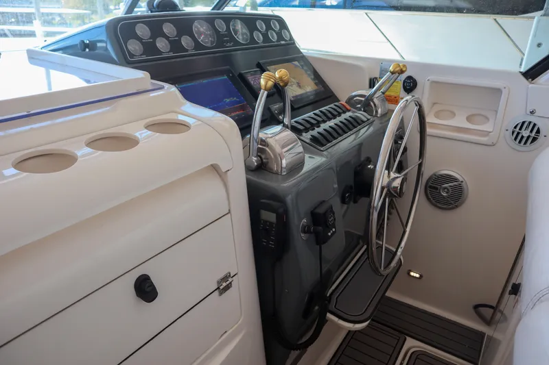 Slide: The Image of 1999 Tiara Yachts 3500 Express helm with steering wheel and control panel. - 152