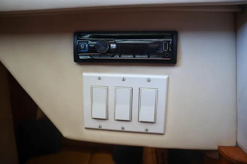 Slide: The Image of 1999 Tiara Yachts 3500 Express interior with stereo and light switches. - 157