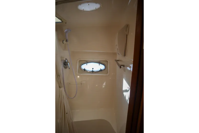 Slide: The Image of Shower area in 1999 Tiara Yachts 3500 Express with porthole and fixtures. - 159