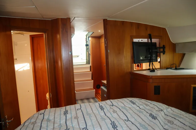Slide: The Image of 1999 Tiara Yachts 3500 Express interior with wood paneling and modern amenities. - 164