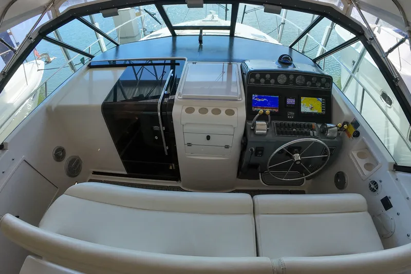 Slide: The Image of 1999 Tiara Yachts 3500 Express cockpit with navigation instruments and steering wheel. - 173