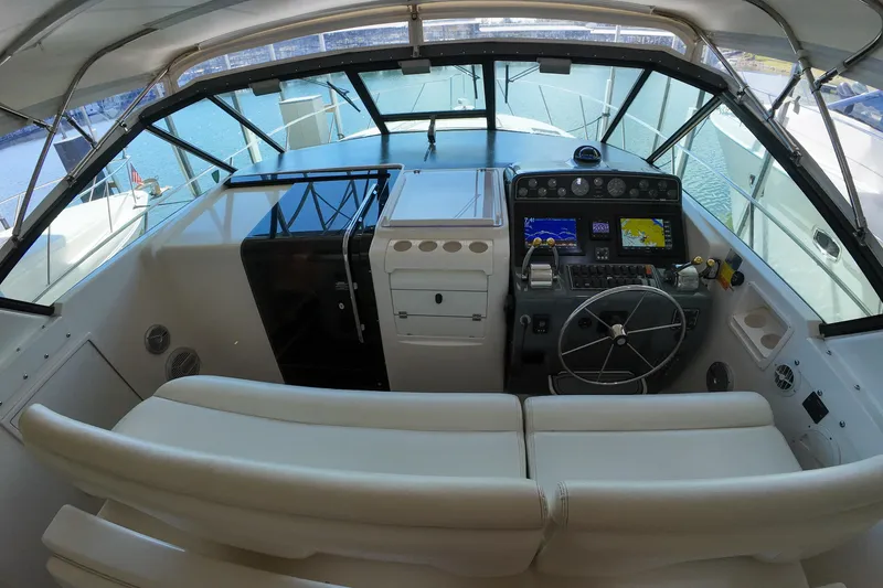 Slide: The Image of 1999 Tiara Yachts 3500 Express helm with navigation equipment and steering wheel. - 174