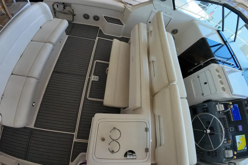 Slide: The Image of 1999 Tiara Yachts 3500 Express cockpit with seating, helm, and navigation equipment. - 175