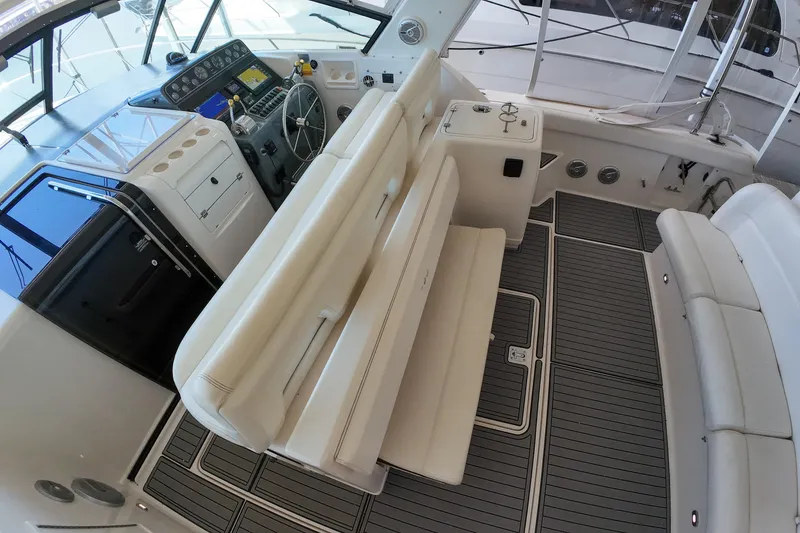 Slide: The Image of 1999 Tiara Yachts 3500 Express interior with helm, seating, and modern dashboard. - 176