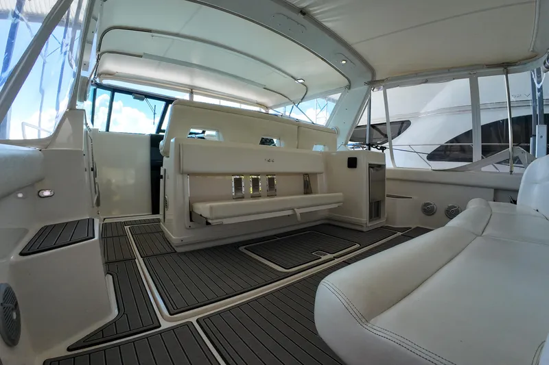 Slide: The Image of 1999 Tiara Yachts 3500 Express interior with white seating and modern design. - 177