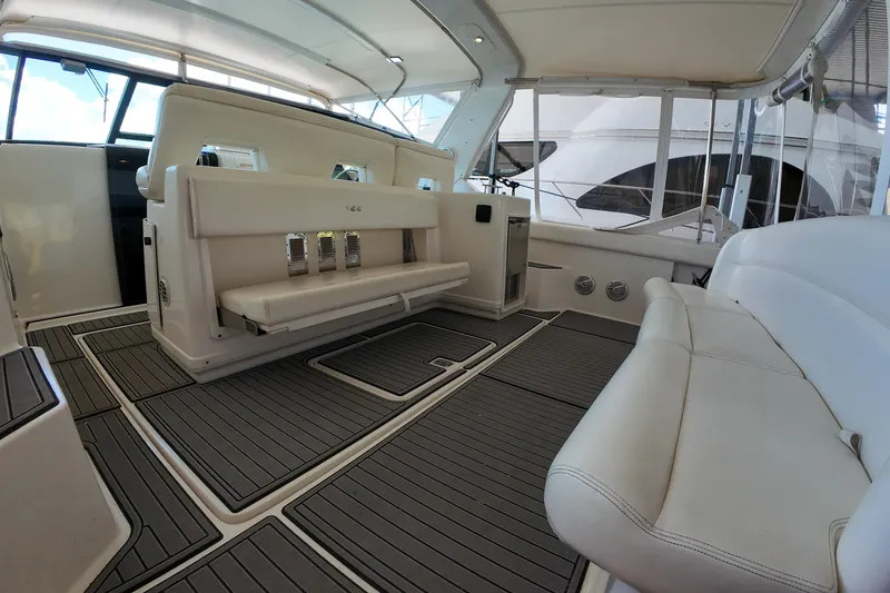 Slide: The Image of 1999 Tiara Yachts 3500 Express interior with white seating and sleek design. - 178
