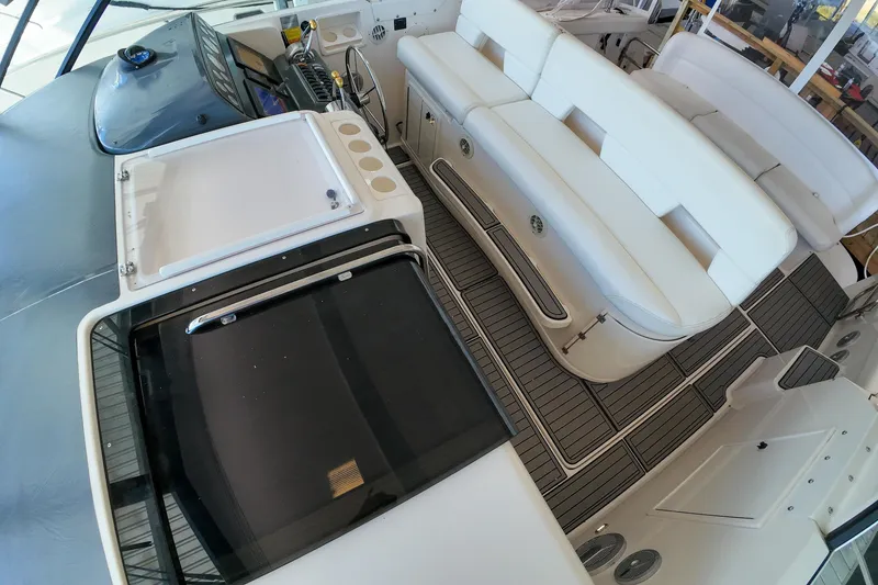 Slide: The Image of 1999 Tiara Yachts 3500 Express interior with white seating and sleek design. - 179