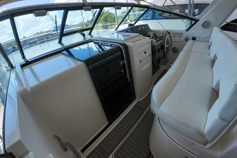 Slide: The Image of 1999 Tiara Yachts 3500 Express cockpit with white seating and control panel. - 181