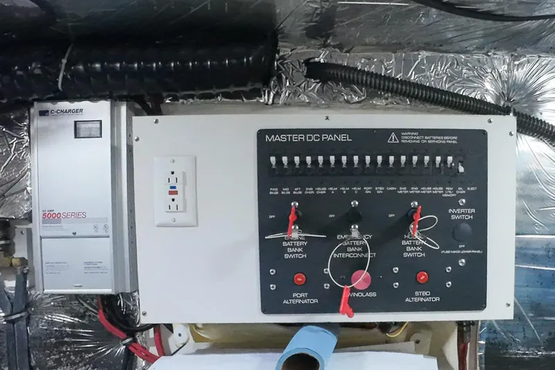 Slide: The Image of Electrical panel and charger in a 1999 Tiara Yachts 3500 Express boat. - 186