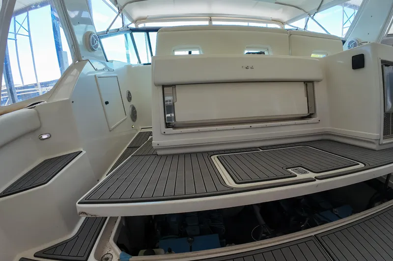Slide: The Image of 1999 Tiara Yachts 3500 Express interior with seating and storage compartments. - 192