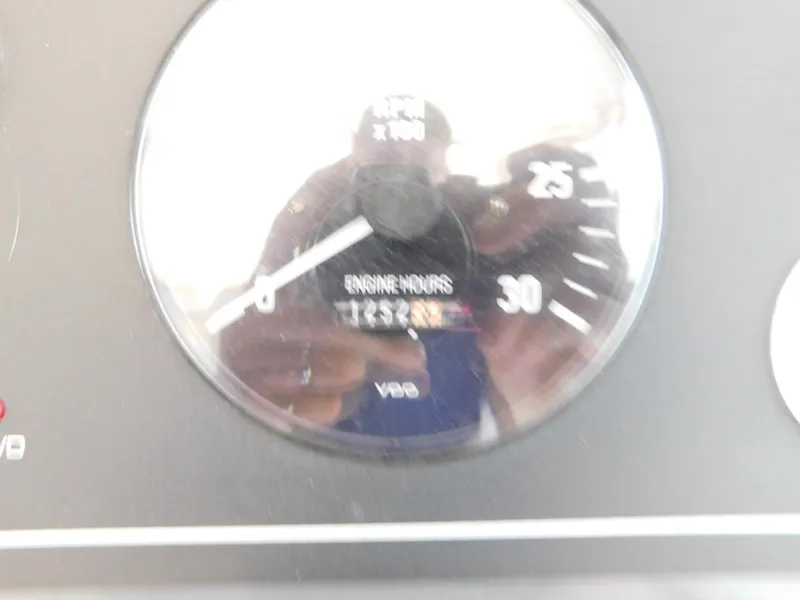 Slide: The Image of Close-up of Tiara Yachts 3500 Express 1999 engine hours gauge showing 1253. - 21